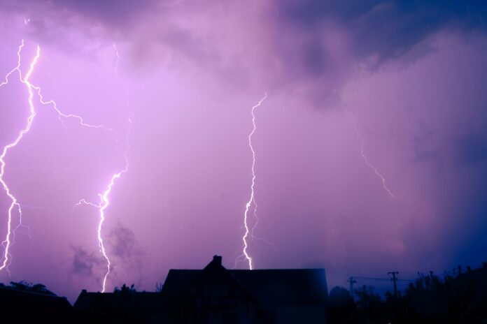 A lightning storm is seen over a residential area